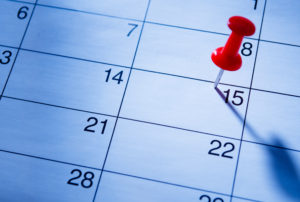 Red pin marking the 15th on a calendar