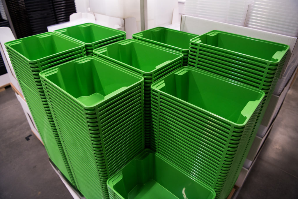Many folding green boxes containers at store